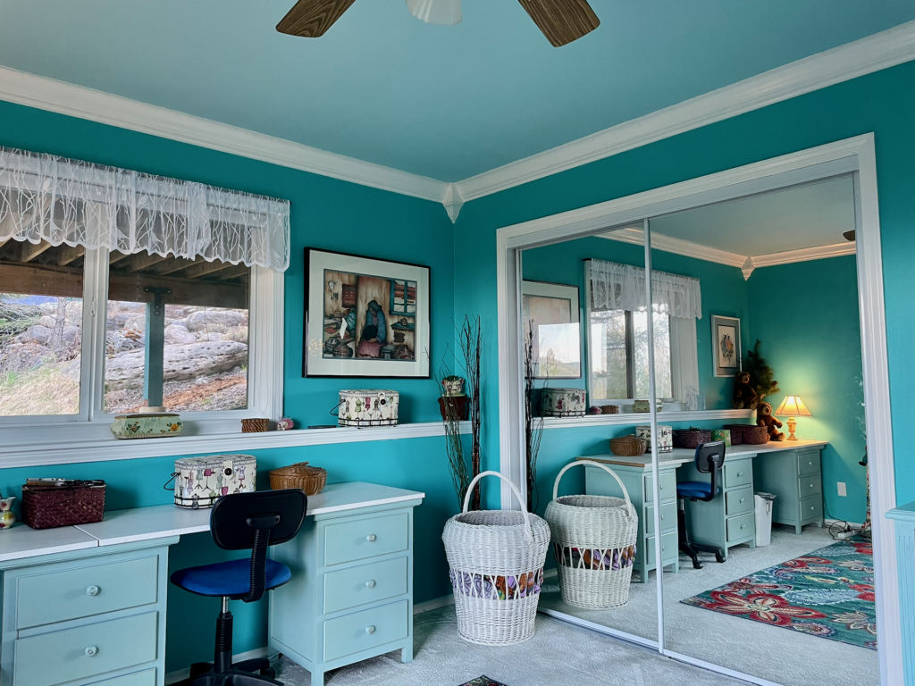Another view of the second bedroom showing window with ledging along that wall and mirrored closet doors