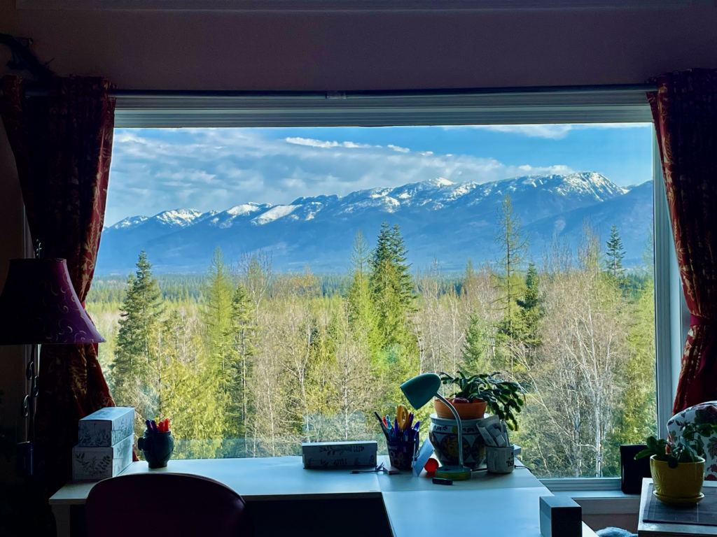 Snow capped blue-sky view of the Swan Range taken from behind the desk in the great room.