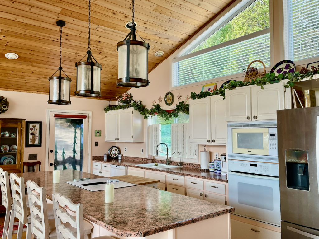 Close up of the counters (salmon, pink, grey and black) and cabinets (off white.)