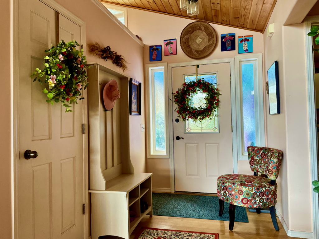 The front entryway with hall coat-closet on the left and entrance to laundry room and half-bath on the right.