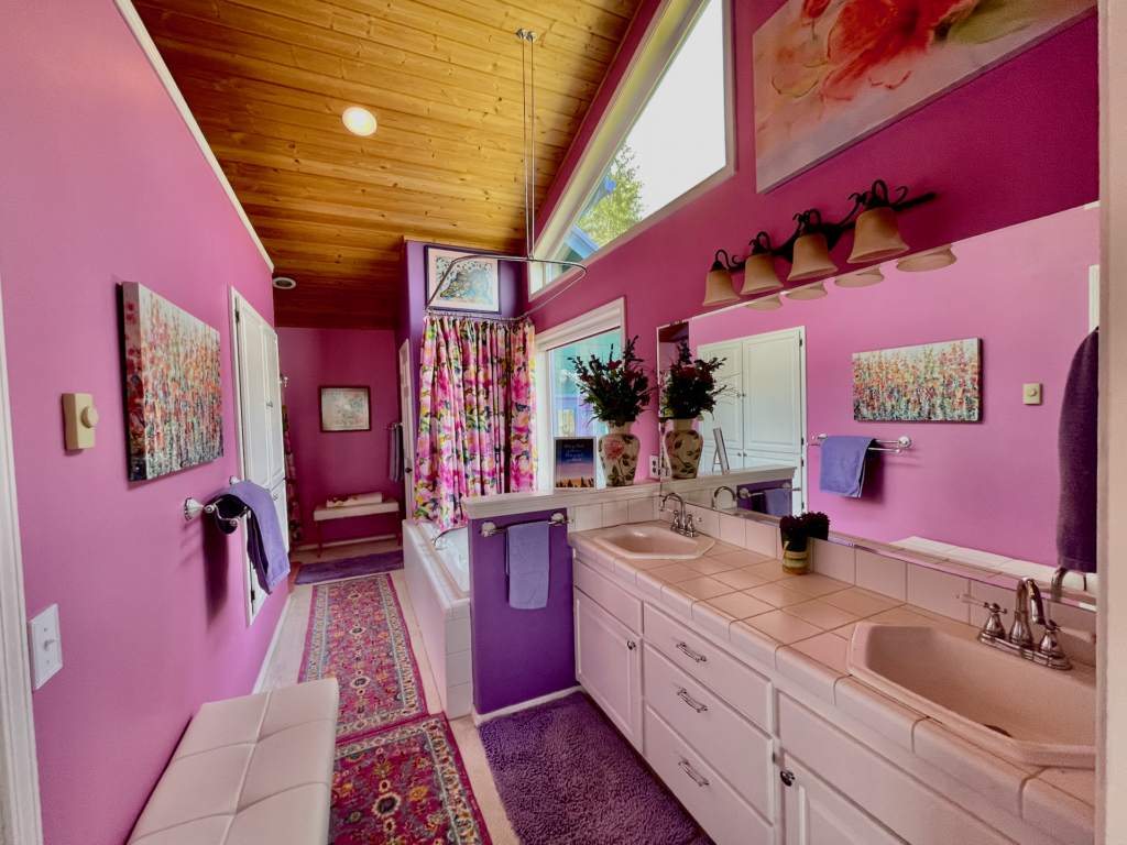 Playful, colorful bath with pinks and purples. Double sinks, jetted tub.