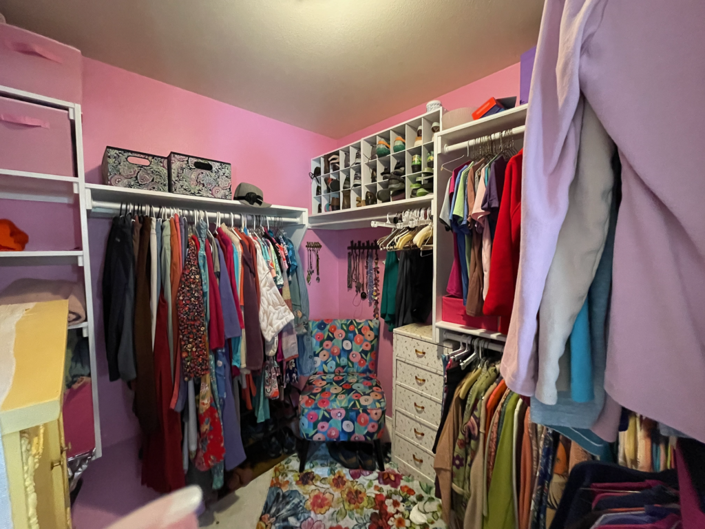Good-sized walk-in closet with room to sit.