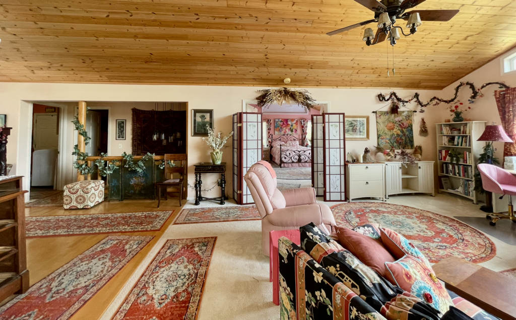 Entrance to master-suite and of the staircase to the lower level as seen from the great room.
