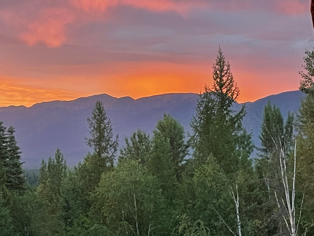 The orange and purples of a sunset over the purple Swan Range.