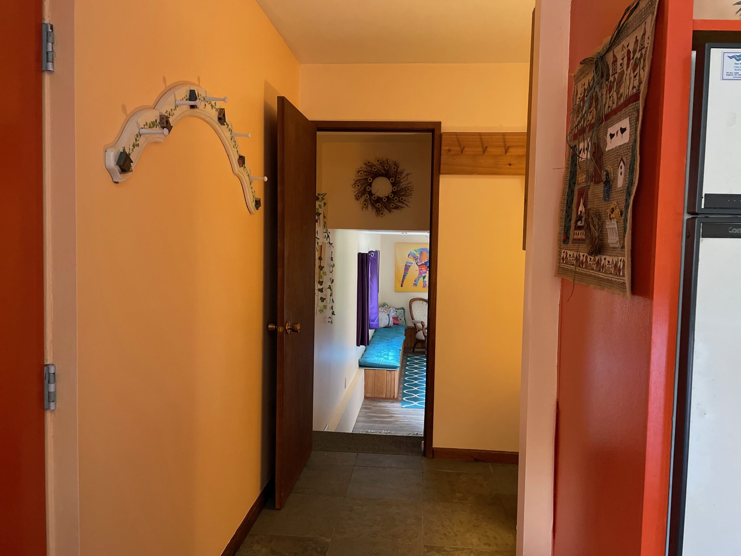 The laundry room and stairs down to the room being used as a bedroom. The picture looks like the walls are yellow and they are actually the same soft peach.